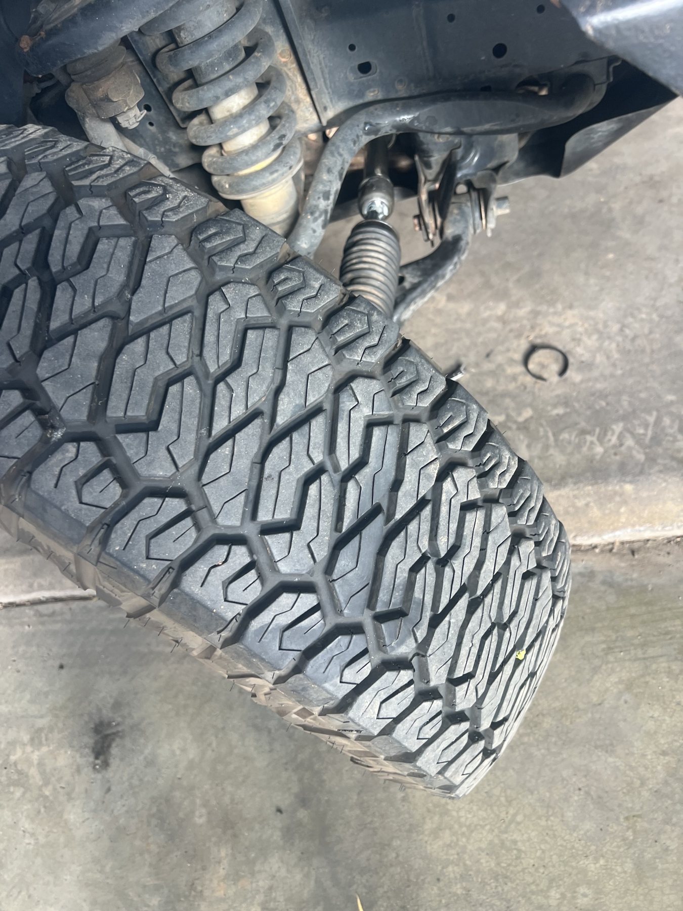 A four wheel drive up on the workshop floor at Forbes Automotive Services, front spring and steering rack exposed